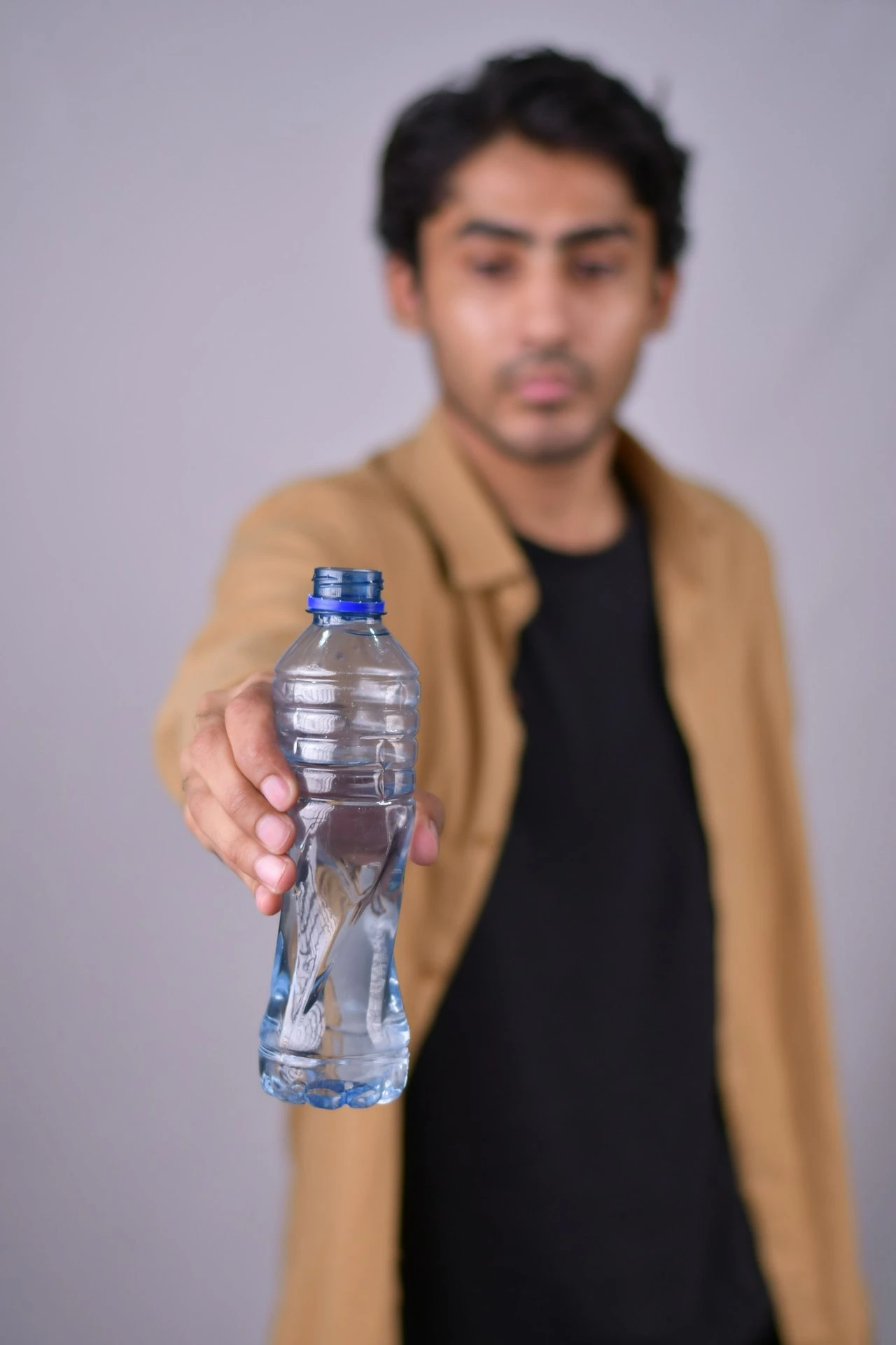 a man holding a bottle of water in his hand